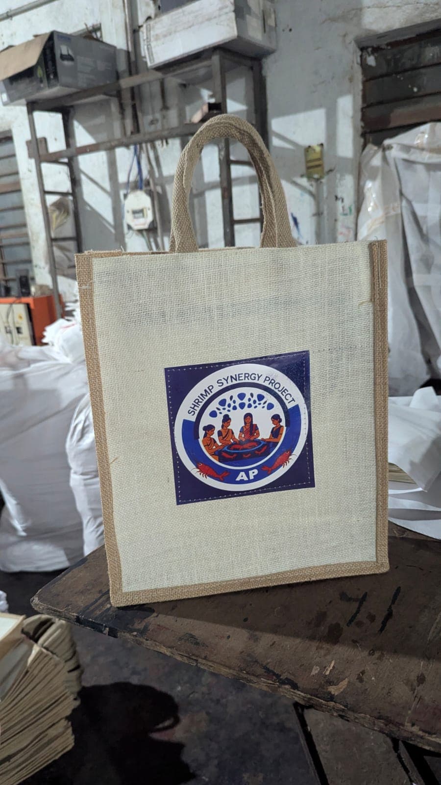Branded jute carrier for the Shrimp Synergy Project on the factory floor